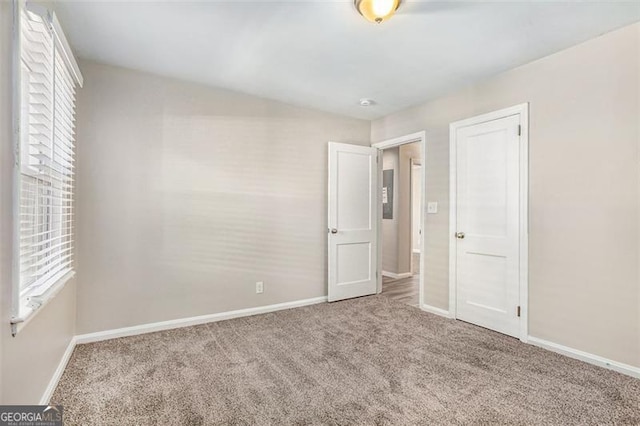 unfurnished bedroom with carpet flooring and a closet