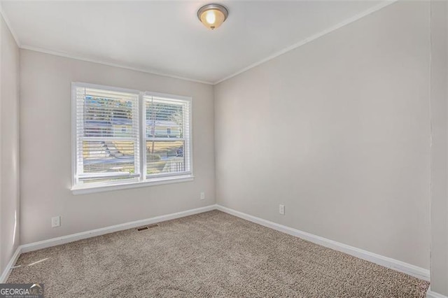 carpeted empty room featuring ornamental molding