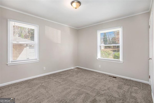 unfurnished room with carpet flooring, plenty of natural light, and ornamental molding