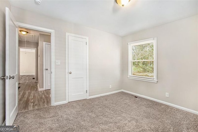 unfurnished bedroom featuring a closet and carpet floors