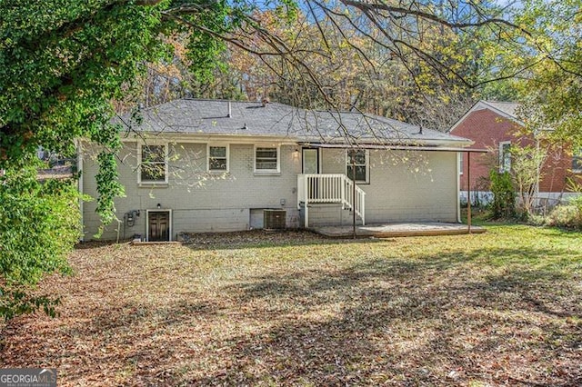 back of house featuring a lawn and cooling unit