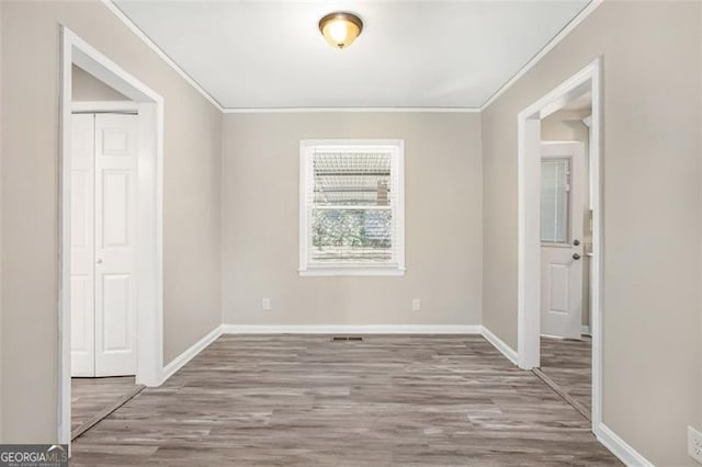 spare room with light hardwood / wood-style floors and ornamental molding