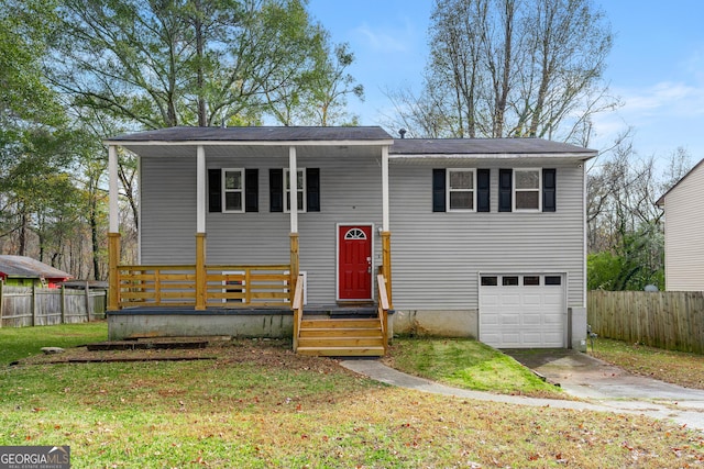 split foyer home with a garage and a front yard