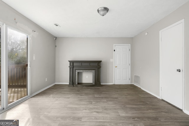 unfurnished living room with hardwood / wood-style floors