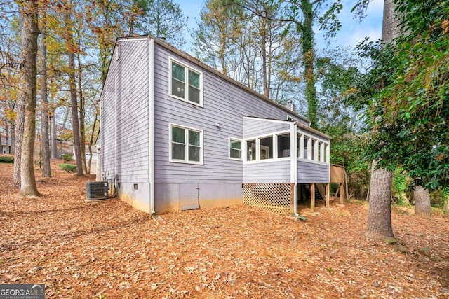 back of property featuring central AC unit and a sunroom