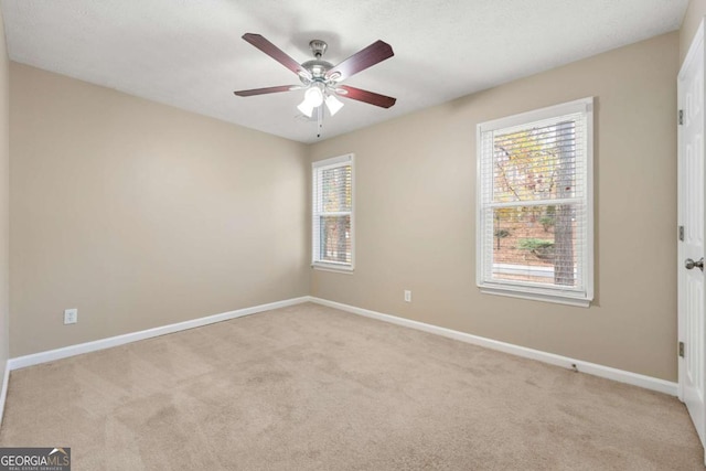 carpeted empty room featuring ceiling fan