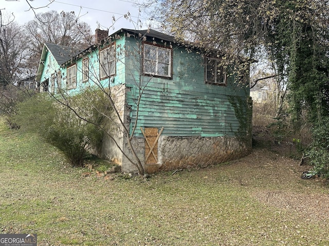 view of property exterior with a yard