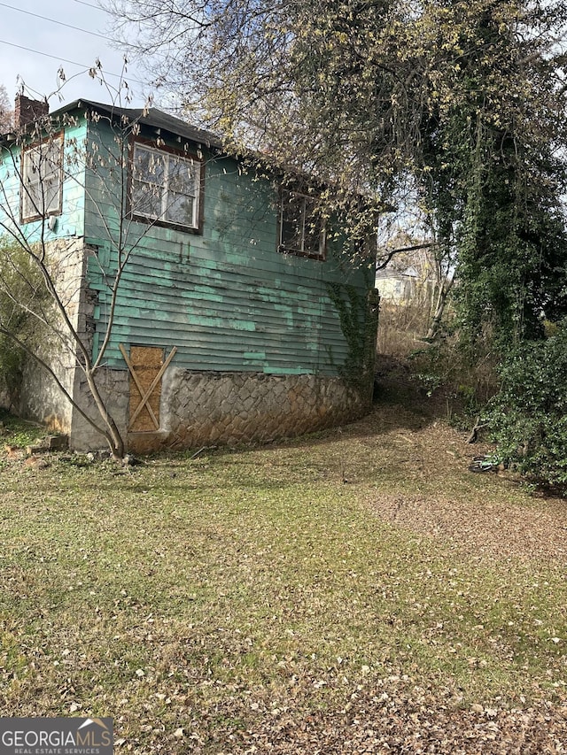 view of home's exterior featuring a lawn