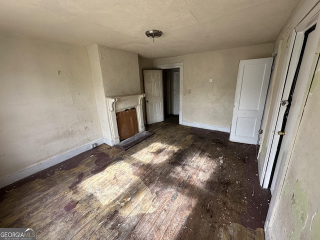 unfurnished living room with dark hardwood / wood-style flooring