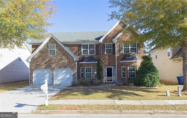 view of front of house featuring a garage and a front lawn