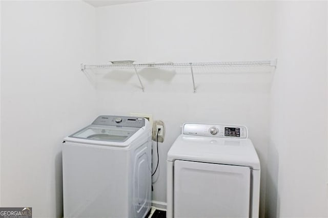 clothes washing area with independent washer and dryer