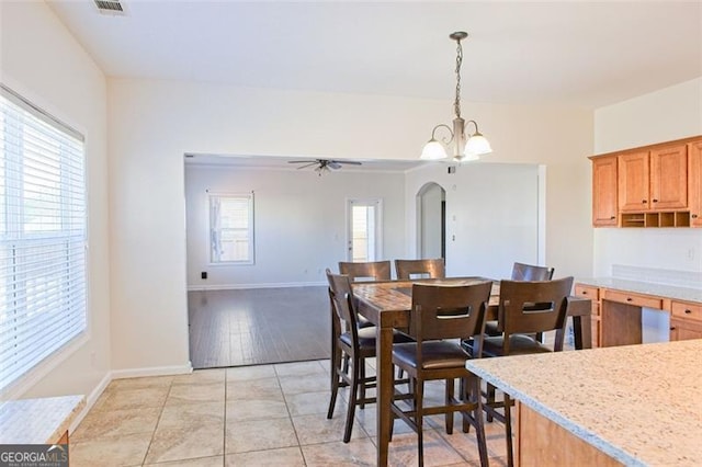 dining area featuring ceiling fan with notable chandelier and light wood-type flooring