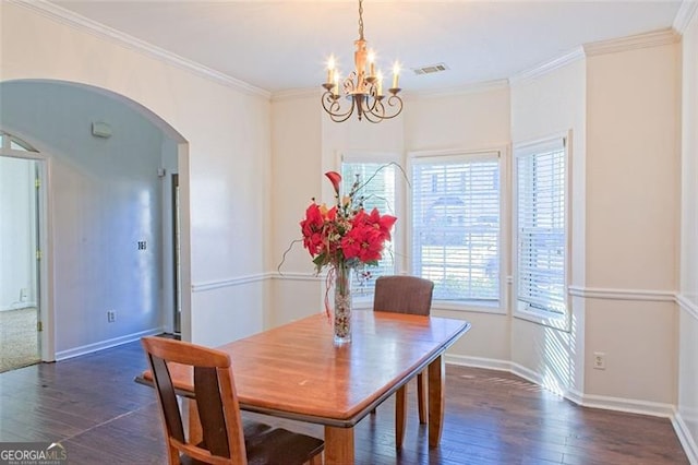 dining space with dark hardwood / wood-style flooring, a chandelier, and ornamental molding