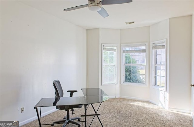 carpeted office with ceiling fan