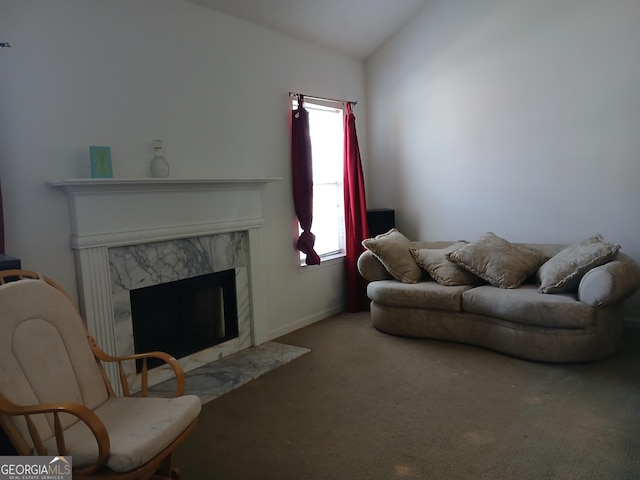 carpeted living room with lofted ceiling and a premium fireplace