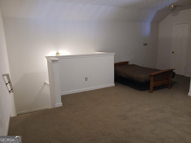 unfurnished bedroom featuring carpet flooring and lofted ceiling