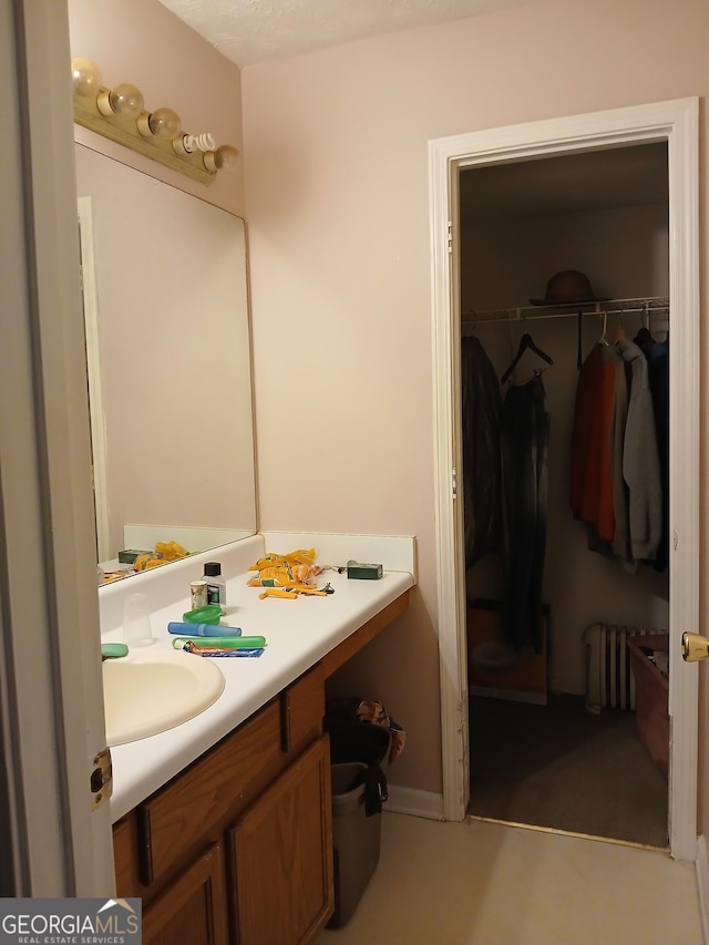 bathroom featuring vanity and radiator heating unit