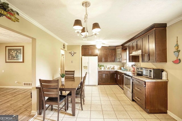 kitchen featuring sink, crown molding, light tile patterned flooring, light stone counters, and stainless steel appliances