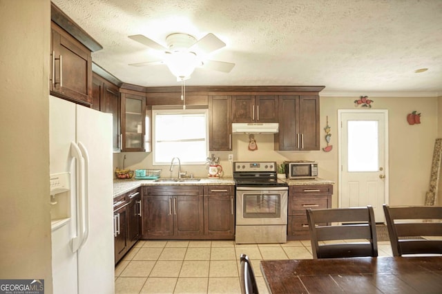 kitchen featuring sink, light tile patterned floors, plenty of natural light, and appliances with stainless steel finishes