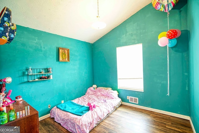 bedroom with wood-type flooring and vaulted ceiling