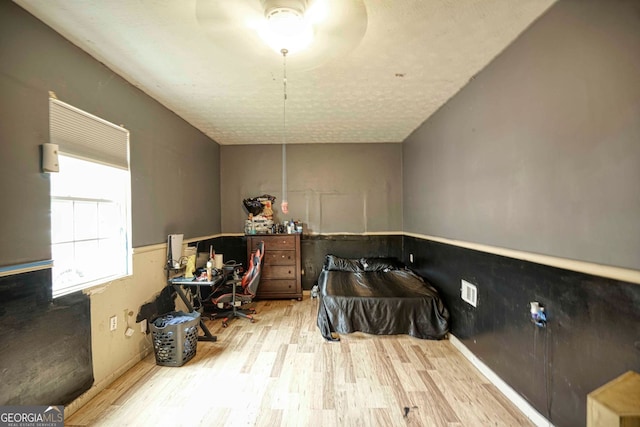 bathroom featuring ceiling fan, hardwood / wood-style floors, and a textured ceiling