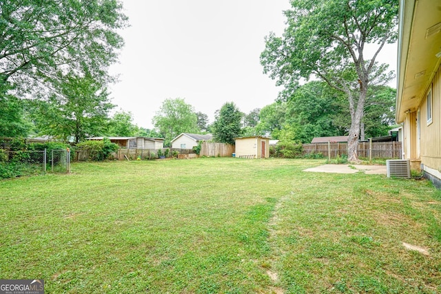 view of yard with a patio and a storage shed