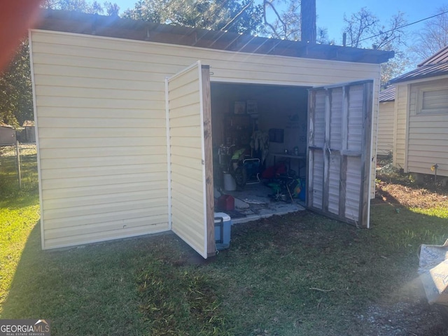 view of outbuilding with a lawn