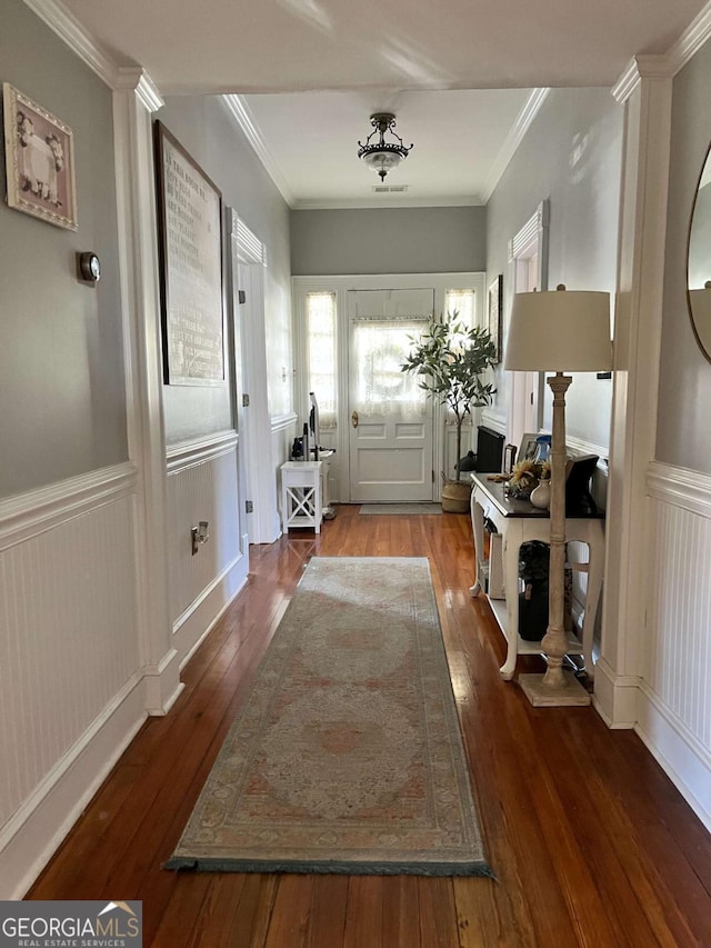 entryway featuring wood-type flooring and ornamental molding