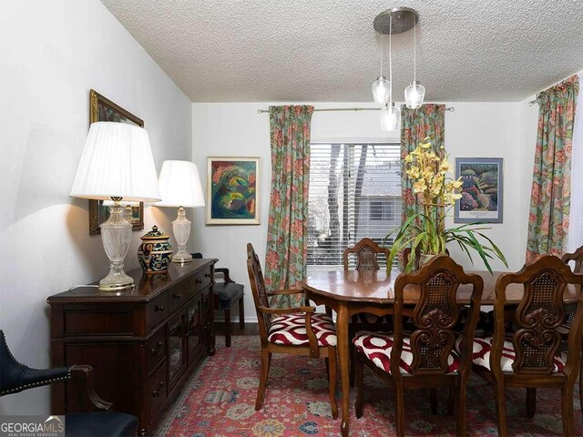 dining room featuring a textured ceiling and an inviting chandelier