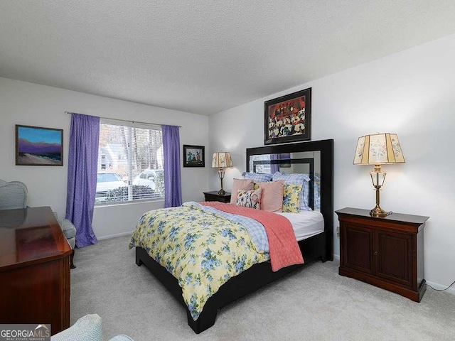 bedroom featuring light carpet and a textured ceiling