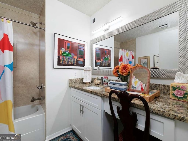 bathroom featuring vanity, a textured ceiling, and shower / bath combo