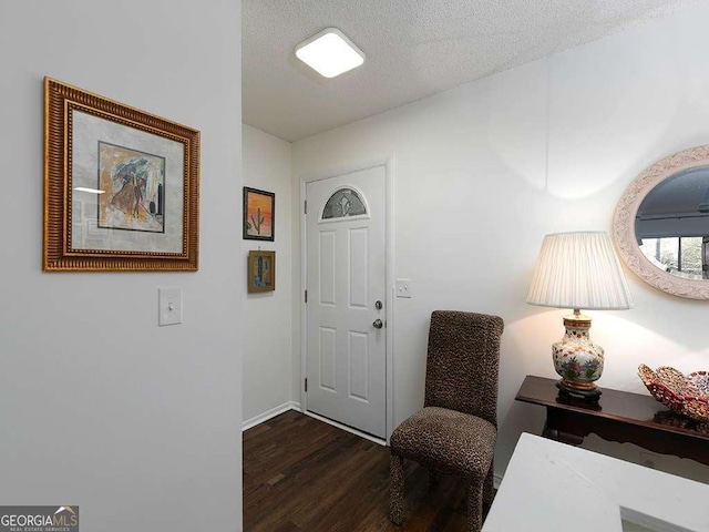 entrance foyer featuring a textured ceiling and dark hardwood / wood-style flooring