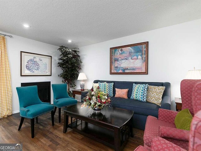 living room featuring hardwood / wood-style floors and a textured ceiling