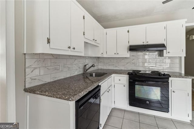 kitchen featuring decorative backsplash, sink, black appliances, dark stone countertops, and white cabinetry