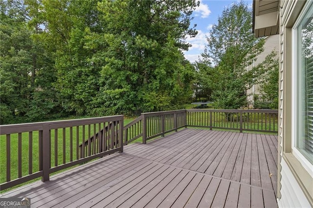 deck featuring a lawn