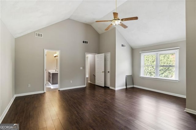 unfurnished bedroom featuring vaulted ceiling, ceiling fan, ensuite bathroom, and dark hardwood / wood-style floors