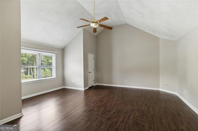 unfurnished living room featuring ceiling fan, lofted ceiling, and dark wood-type flooring