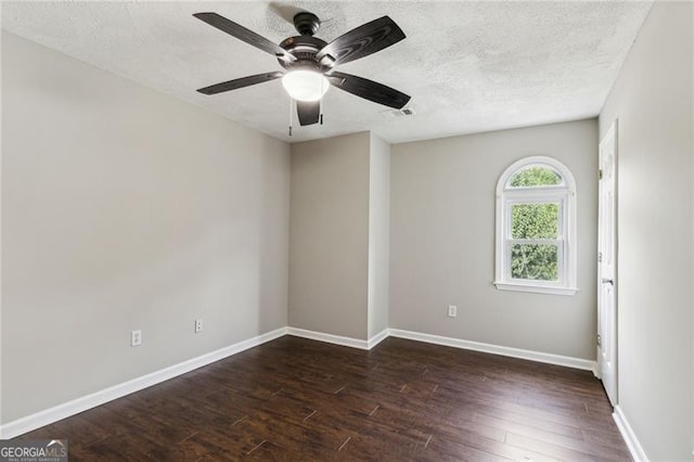 empty room featuring a textured ceiling, dark hardwood / wood-style flooring, and ceiling fan