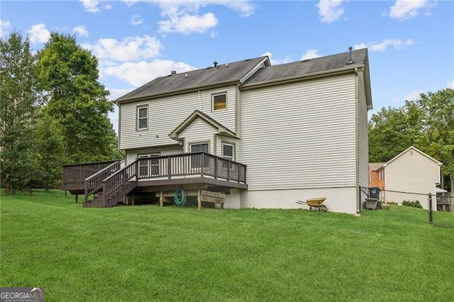 back of property featuring a lawn and a wooden deck