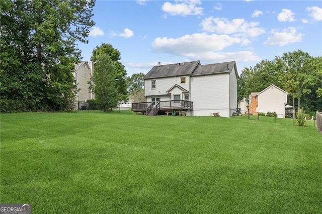 back of house with a yard and a wooden deck