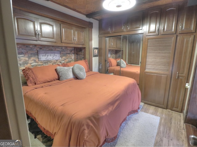 bedroom featuring light hardwood / wood-style floors and a closet