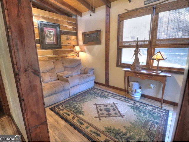 living room featuring vaulted ceiling with beams, wood-type flooring, and wood ceiling