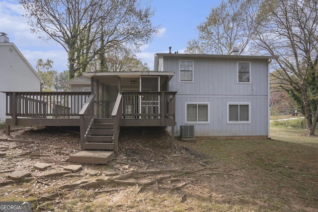 rear view of house featuring central AC, a sunroom, and a wooden deck