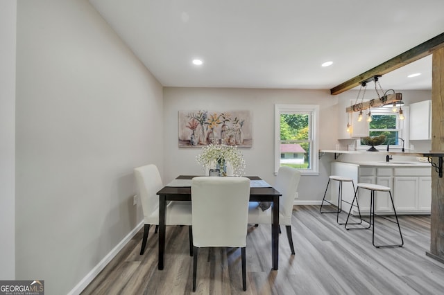 dining area featuring light hardwood / wood-style floors and sink