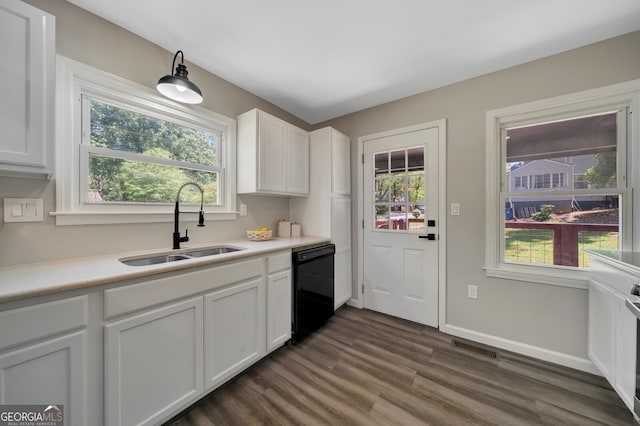 kitchen featuring white cabinets, black dishwasher, plenty of natural light, and sink