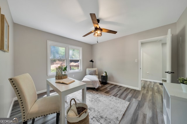 sitting room with wood-type flooring and ceiling fan