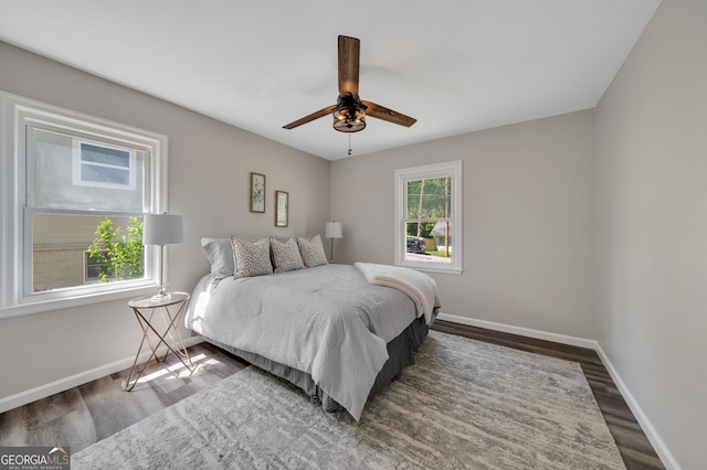 bedroom with ceiling fan and dark wood-type flooring