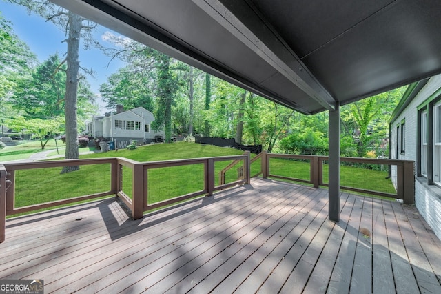 wooden terrace featuring a lawn