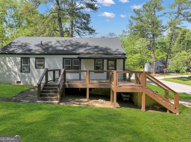 rear view of house with a deck and a lawn