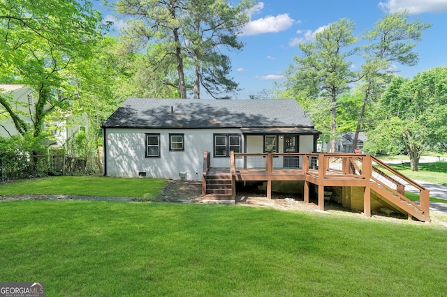 rear view of house with a lawn and a wooden deck